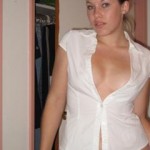 Woman in skimpy shirt that is mostly unbuttoned.