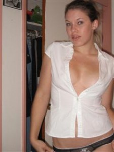 Woman in skimpy shirt that is mostly unbuttoned.